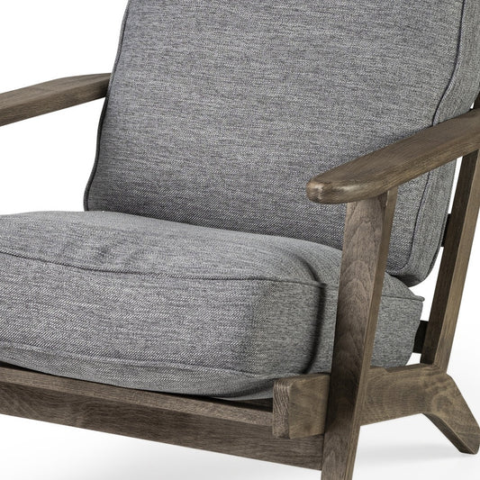 Gray upholstered chair with wooden armrests on a white background