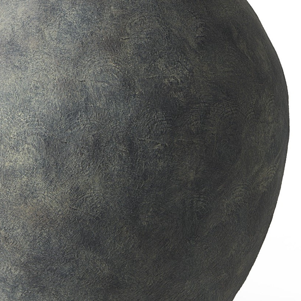 Close-up of a textured dark gray sphere on a white background