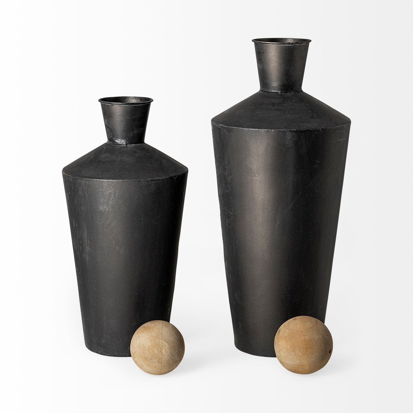 Two black vases on a white background