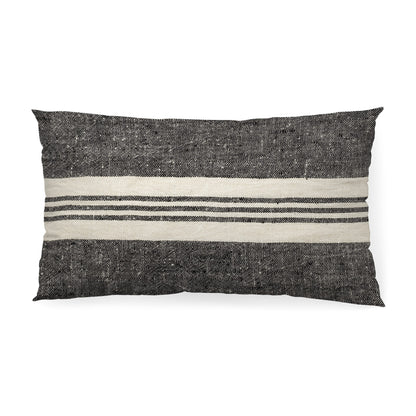 Black and white striped pillow on a white background