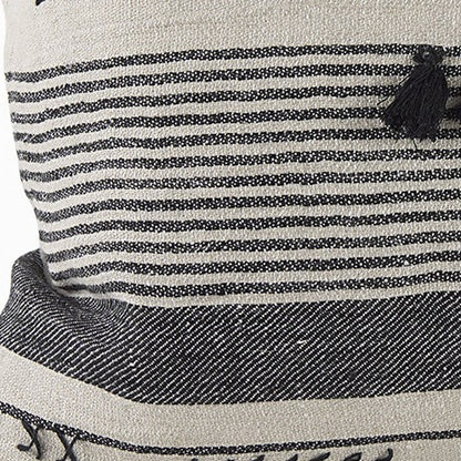 Close-up of a striped fabric with a tassel on a product, likely a bag or pouch.