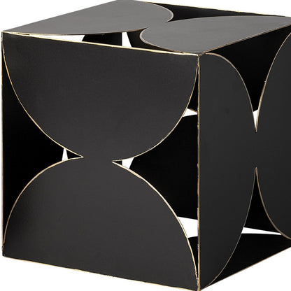 Black geometric side table with gold accents on a white background