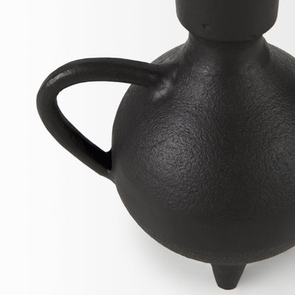 Black ceramic vase with a handle on a white background