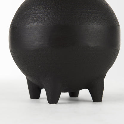 Black ceramic vase with a textured surface on a white background