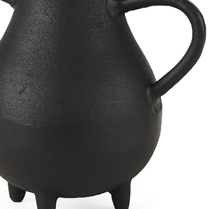 Black ceramic teapot with a handle on a white background