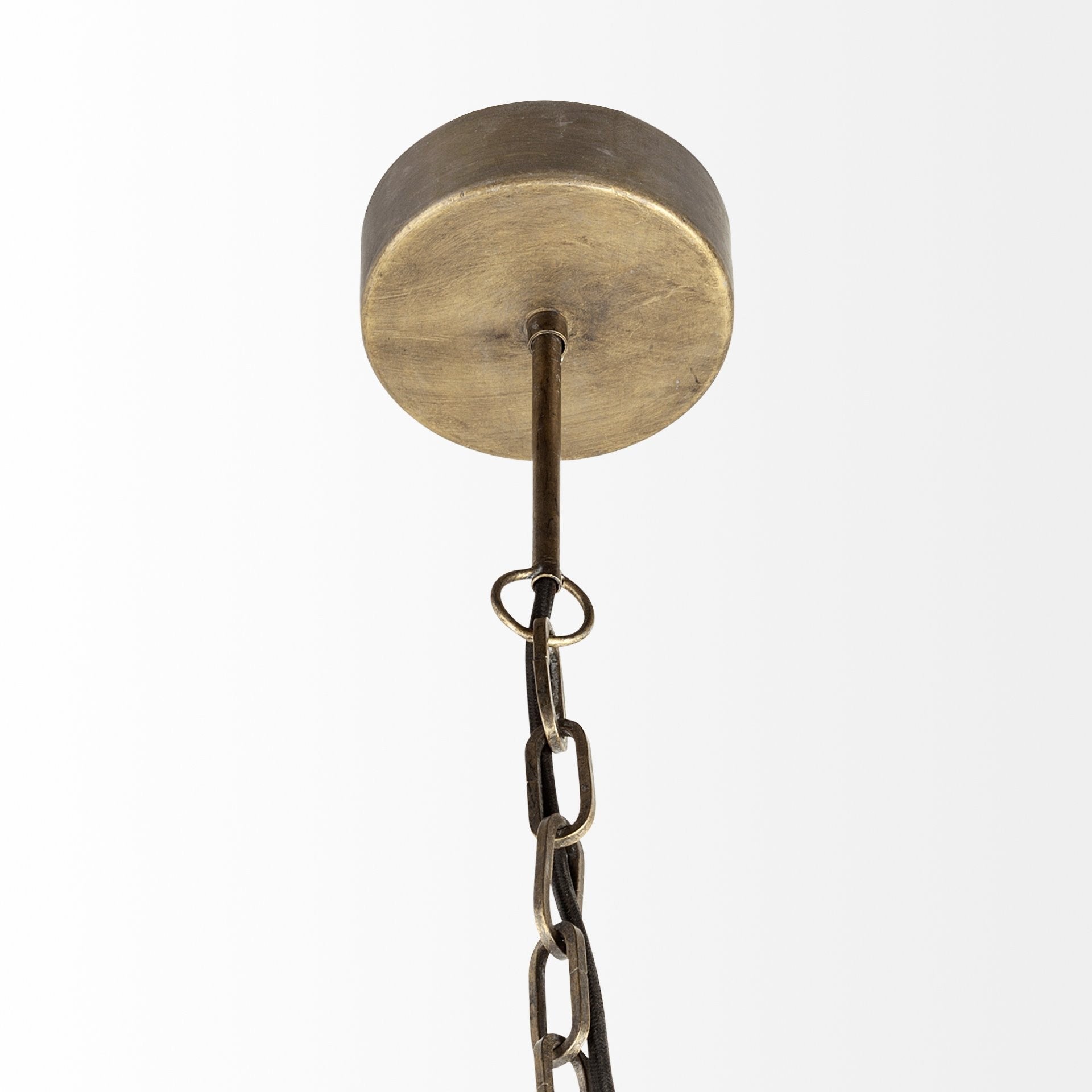 Brass ceiling light fixture with chain on a white background