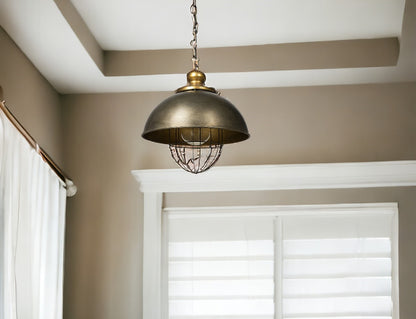 Bronze pendant light hanging in a room with neutral walls and a window.