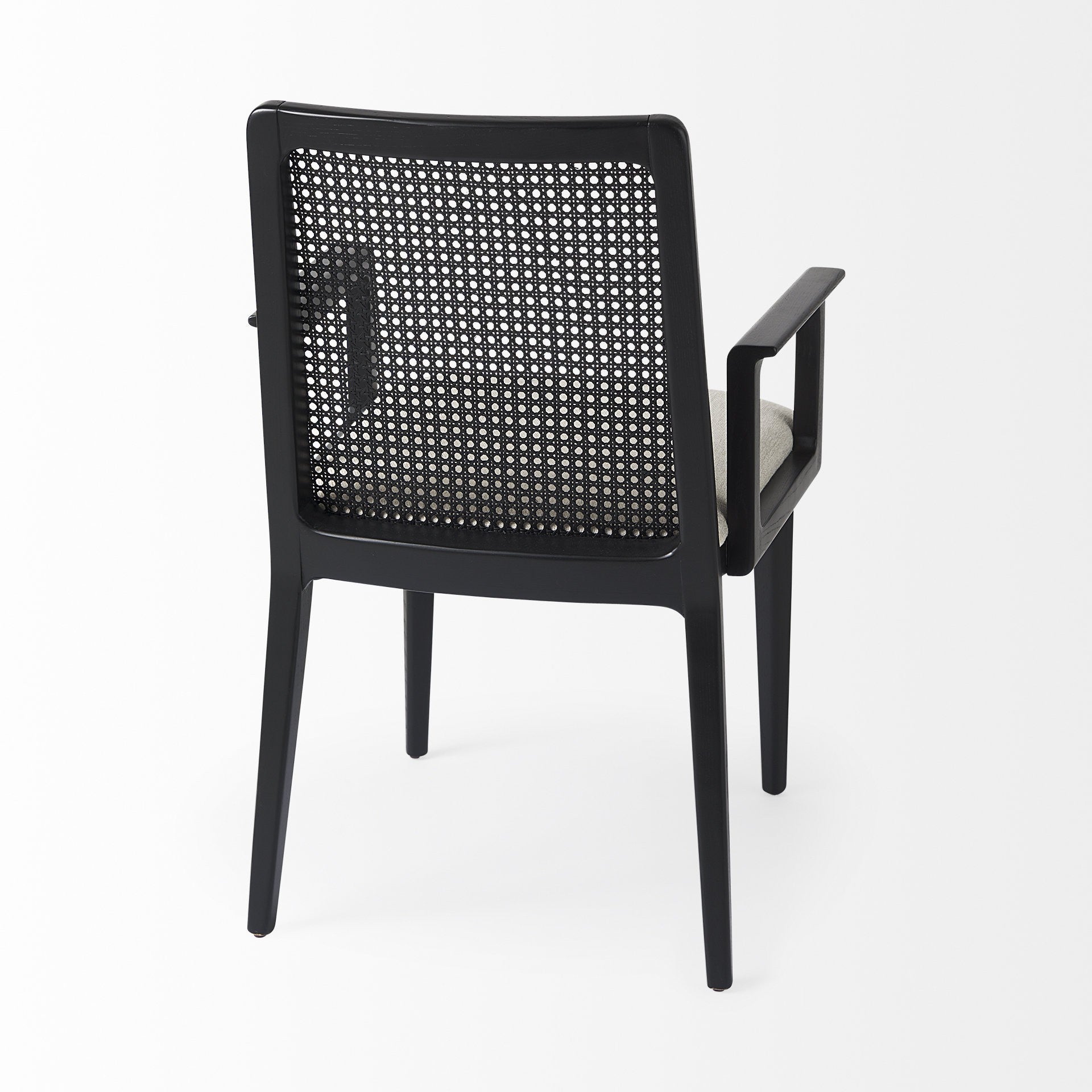 Black chair with woven backrest on a white background