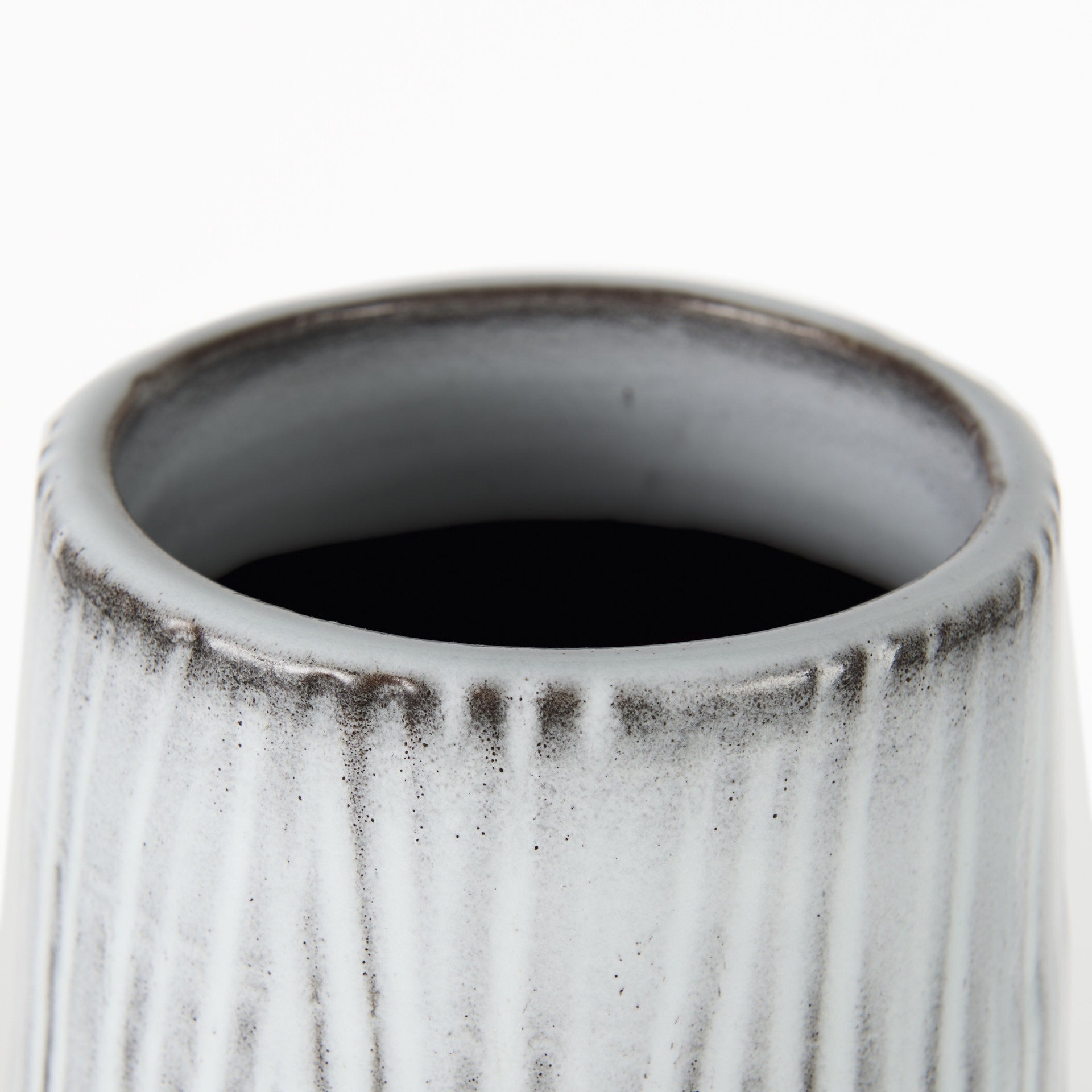 Close-up of a textured ceramic vase on a white background