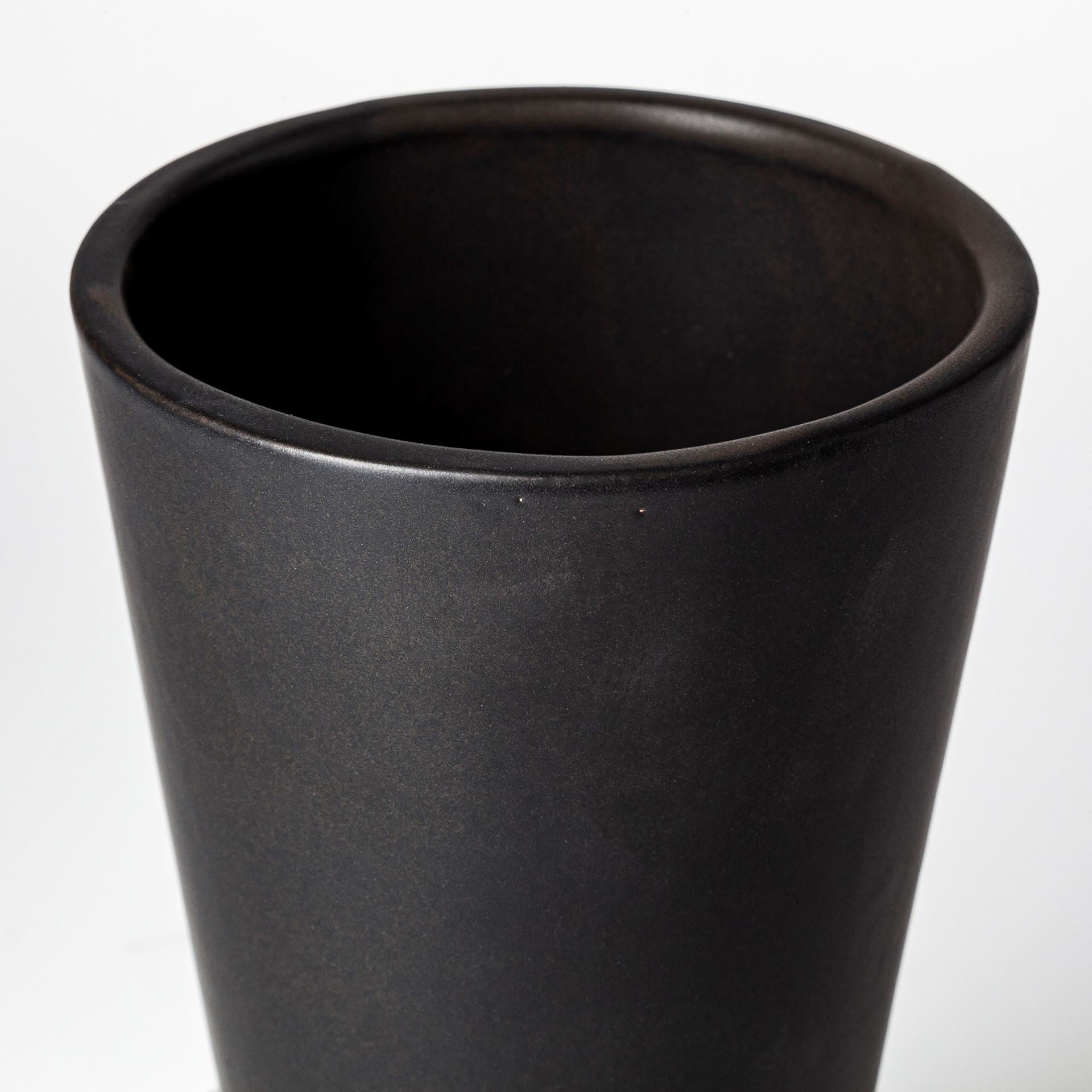 Black ceramic vase on a white background
