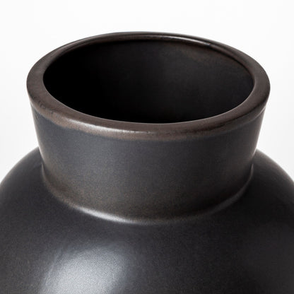 Close-up of a black ceramic vase on a white background