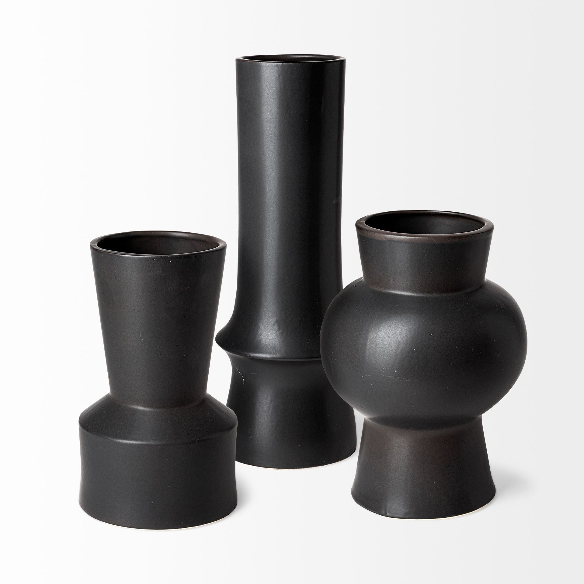 Three black vases of different shapes on a white background