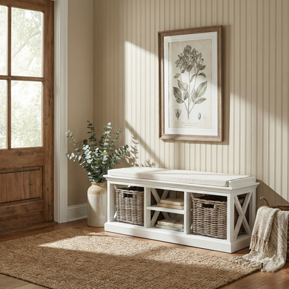 White wooden bench with storage baskets in a room with a window, plant, and framed artwork.