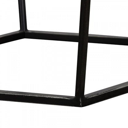 Close-up of a black metal chair frame on a white background