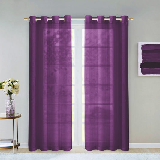 Purple curtains with grommets on a window, with a small table and flowers in the foreground.