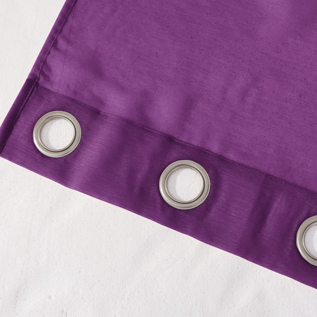 Close-up of a purple curtain with metallic eyelets on a white background