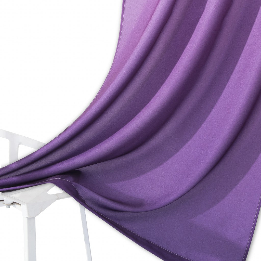 Purple fabric draped over a white chair on a white background