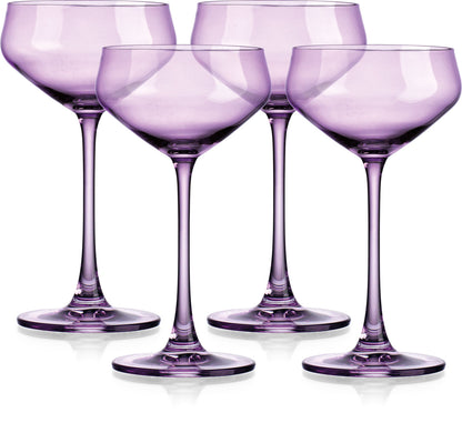 Set of four purple wine glasses on a white background