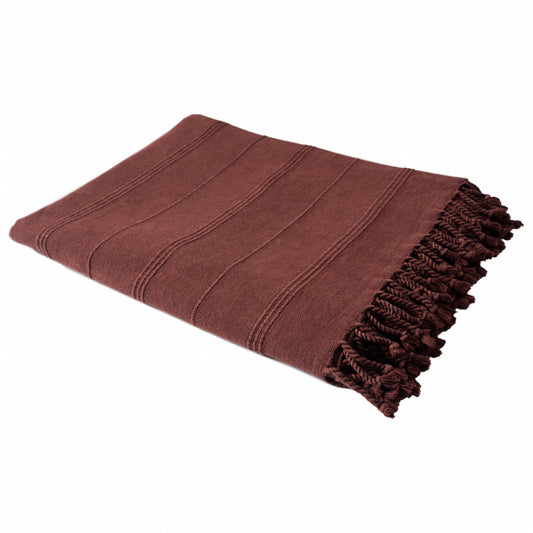 Folded brown blanket with frayed edge on a white background
