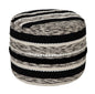 Woven basket with black and white striped pattern on a white background