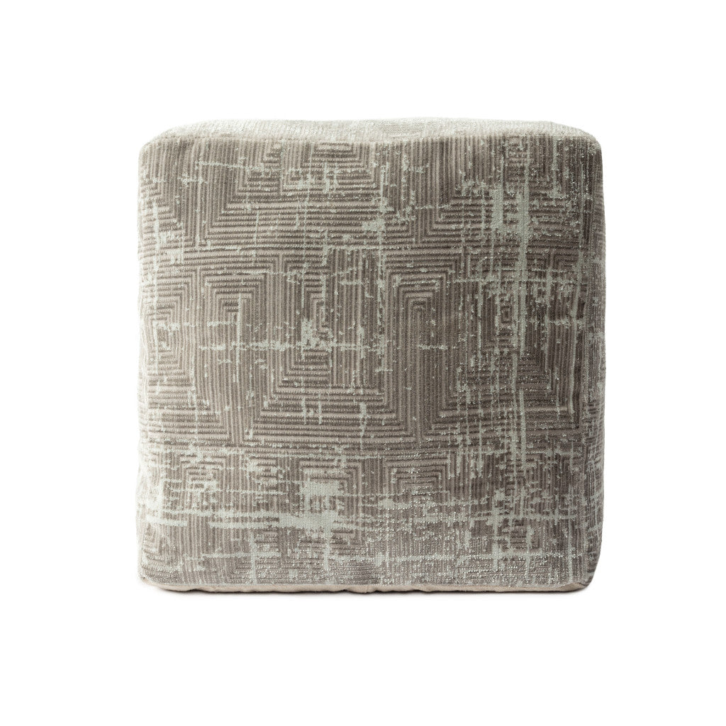 Textured square ottoman with geometric pattern on a white background