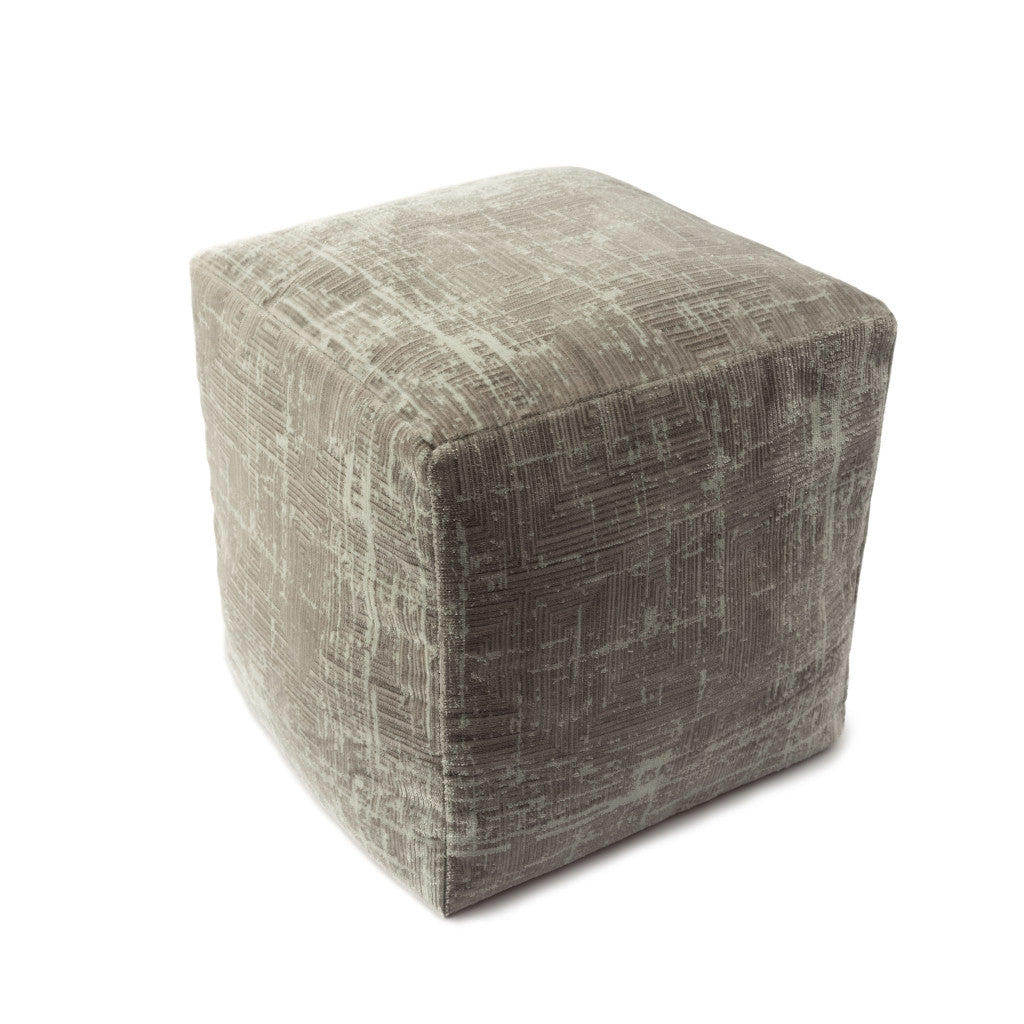 Textured cube-shaped ottoman on a white background