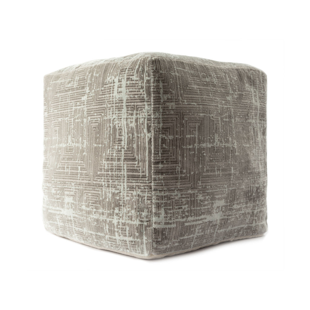 Textured cube-shaped ottoman on a white background