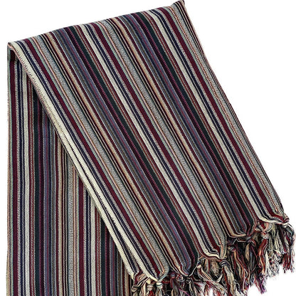 Striped blanket with fringes on a white background