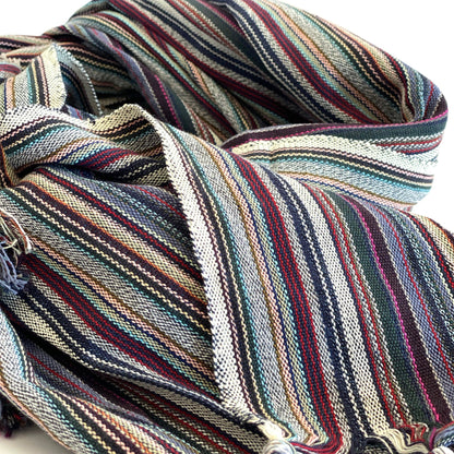 Multicolored striped fabric with tassels on a white background