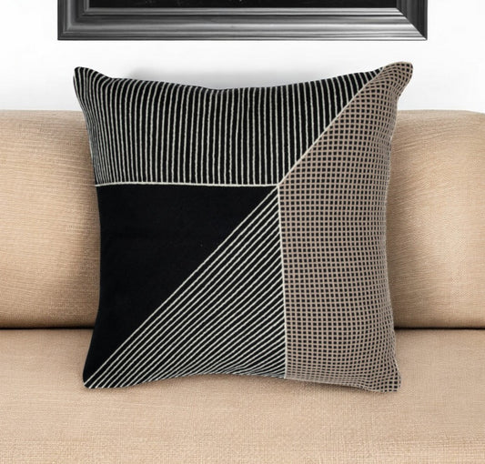 Decorative pillow with geometric pattern on a beige sofa