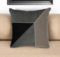 Decorative pillow with geometric pattern on a beige sofa