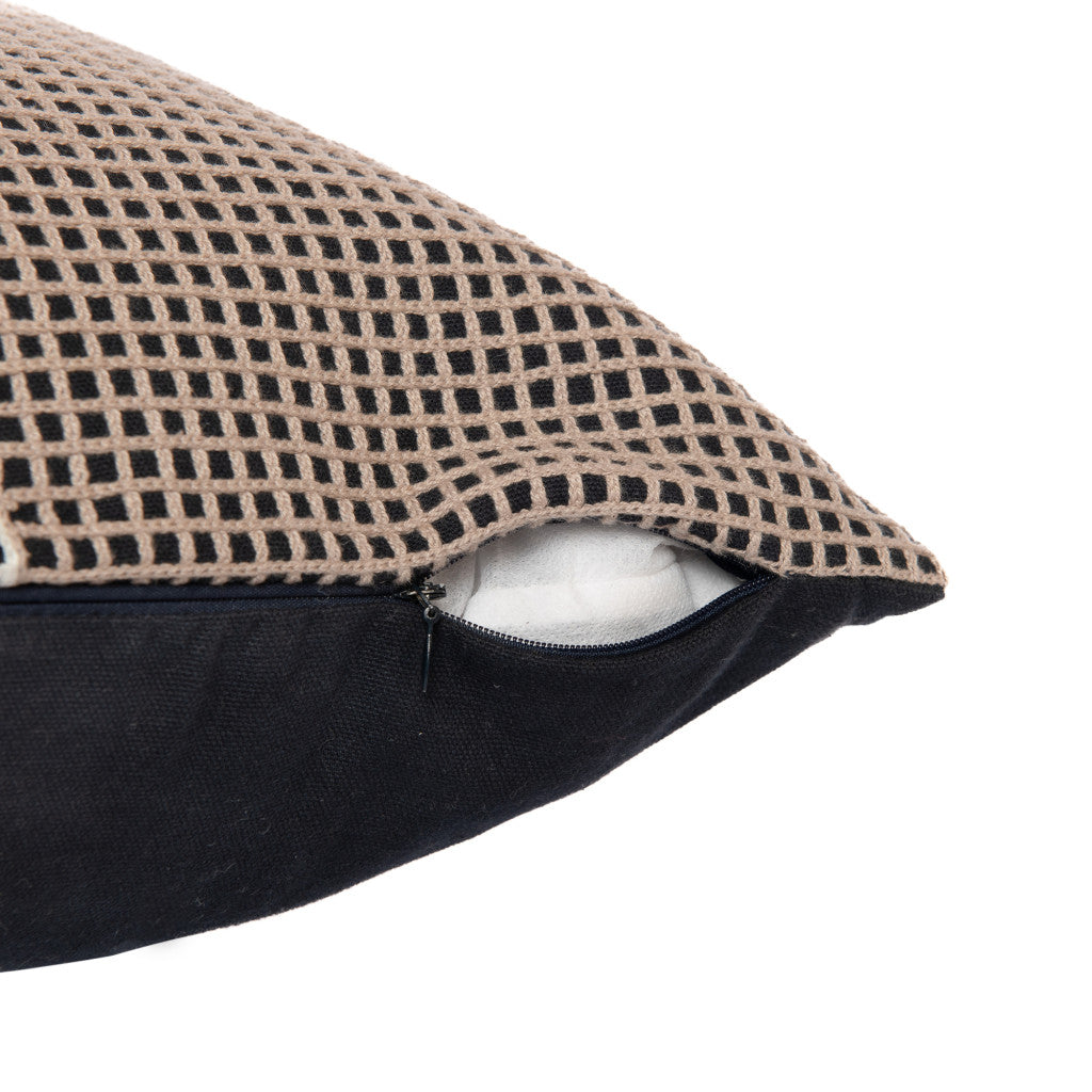 Close-up of a pillow with a textured beige cover and black zipper on a white background