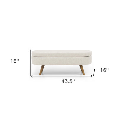 Beige linen upholstered storage bench with wood legs from the Palisades fall collection