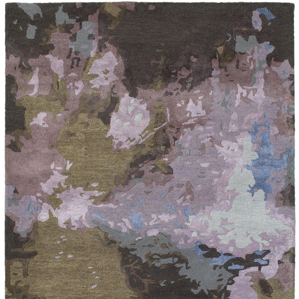 Multicolored abstract patterned rug with shades of green, purple, and blue.