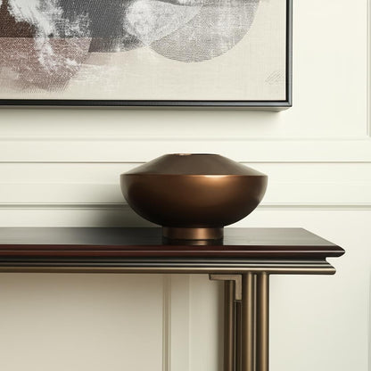 Antiqued bronze vase styled on a console table