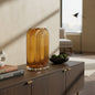 Amber glass table vase from the Palisades fall collection on a console table