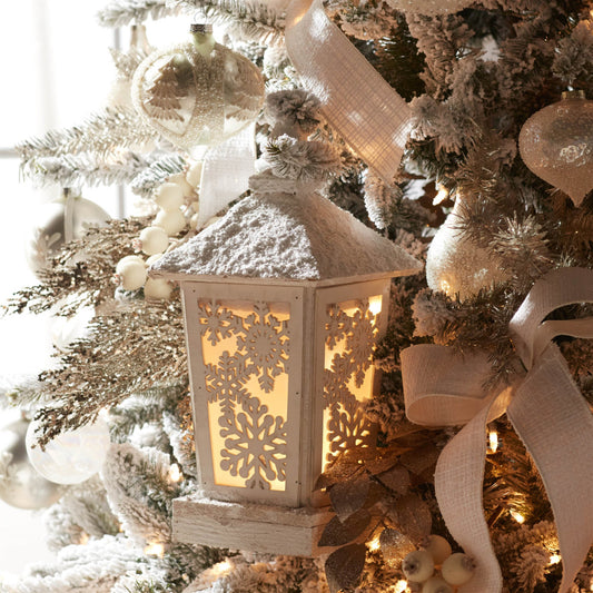 Decorative lantern on a Christmas tree with lights and ornaments