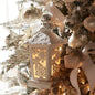 Decorative lantern on a Christmas tree with lights and ornaments