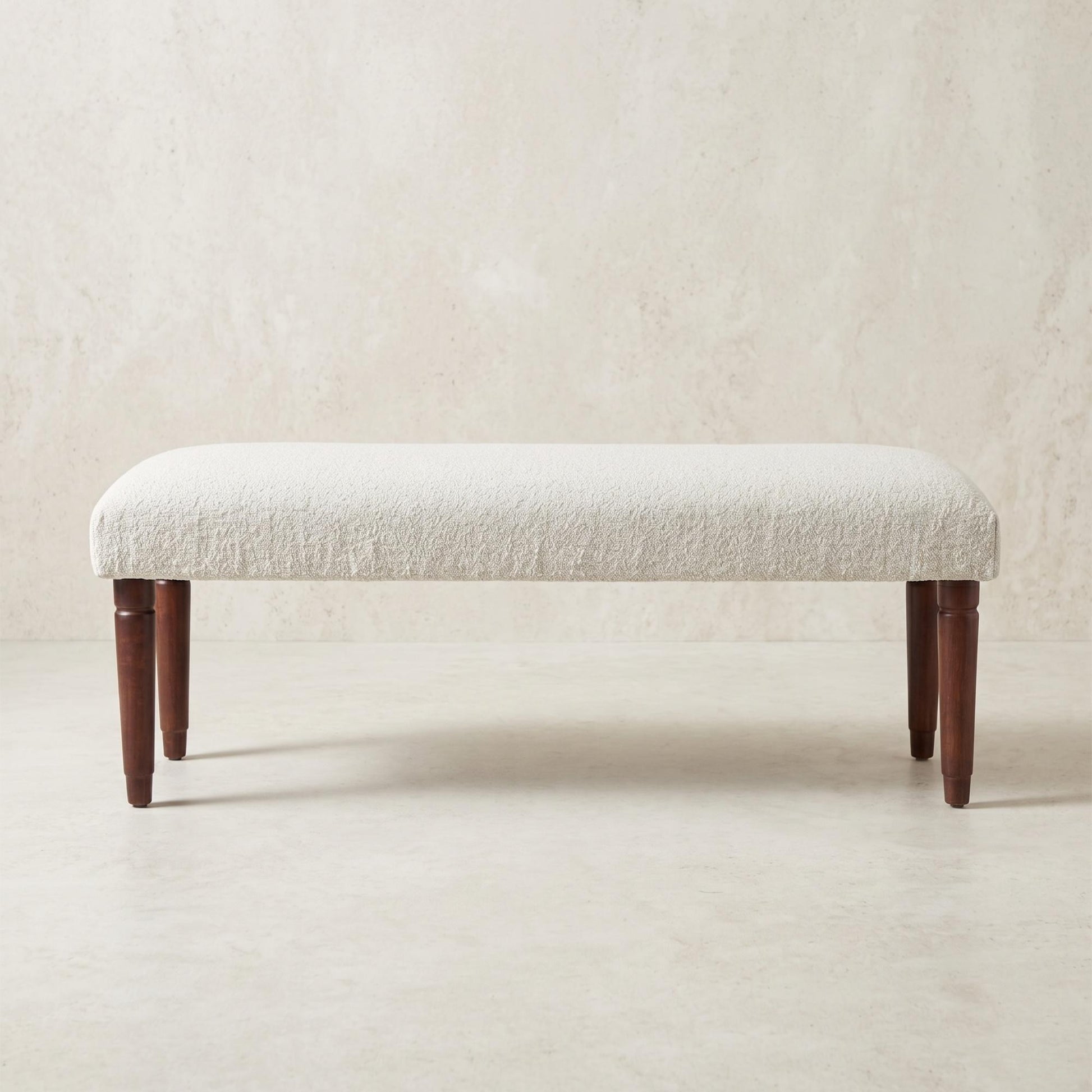 Cream boucle upholstered bench with mango wood legs from the Palisades fall collection
