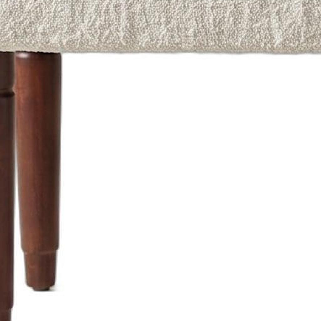 Distressed mango wood leg detail on the Palisades boucle bench